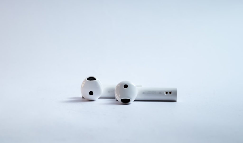 Wireless Bluetooth earphones for music on white background.