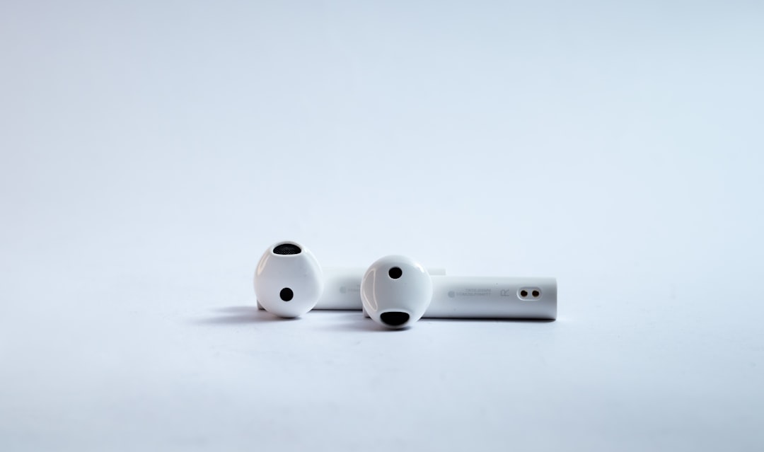 Wireless Bluetooth earphones for music on white background.