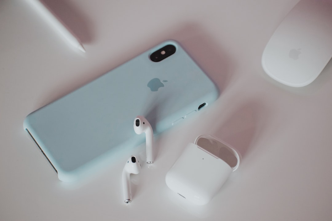 an-iphone-ear-buds-and-headphones-on-a-table-vdtgx5wjwao